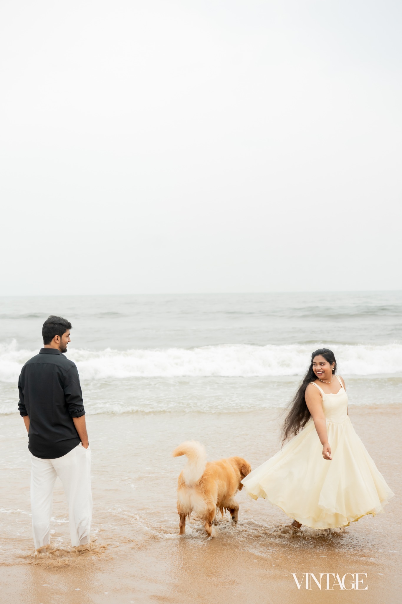 Ratan and Betsy enjoying the beach with their golden dog